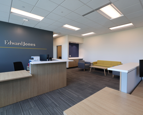 Edward Jones Anchorage Office in SIRI building showing reception desk, Edward Jones logo on the wall, reception lounge or waiting area with coffee table and lounge seating,