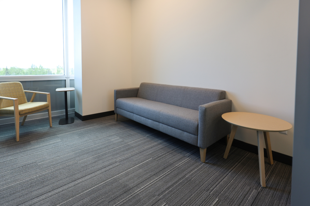 Edward Jones Anchorage office in SIRI building small meeting room / call room with lounge sofa, lounge chair, laptop table and coffee table.
